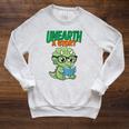 Women's Unearth a Story Summer Reading 2026 Triceratops Dino Book Raglan Sleeve Sweatshirt Heather Mustard