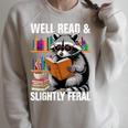 Well Read & Slightly Feral Raccoon Book Lover Graphic Raglan Sleeve Sweatshirt Heather Forest