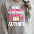 Never Underestimate An Old Woman Author Write Book Raglan Sleeve Sweatshirt Heather Forest