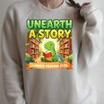 Unearth A Story Dinosaur Summer Reading 2026 Books Raglan Sleeve Sweatshirt Heather Forest