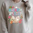 Unearth A Story Library Book Reading Program 2026 Summer Raglan Sleeve Sweatshirt Heather Forest Unearth A Story Library Book Reading Program 2026 Summer Raglan Sleeve Sweatshirt Heather Forest