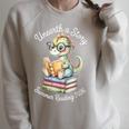Unearth A Story Summer Reading 2026 Cute Dino Book Lover Raglan Sleeve Sweatshirt Heather Forest