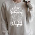 IN A WORLD FULL OF BOOKWORMS BE A Book Dragon Reader Raglan Sleeve Sweatshirt Heather Forest