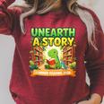 Unearth A Story Dinosaur Summer Reading 2026 Books Raglan Sleeve Sweatshirt Heather Dust