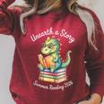 Unearth a Story Summer Reading 2026 Book Lovers Fun Raglan Sleeve Sweatshirt Heather Dust