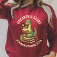 Unreath a Story Summer Library Reading 2026 Dinosaur Book Raglan Sleeve Sweatshirt Heather Dust