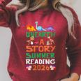 Women's Unearth A Story Summer Reading Program 2026 Dinosaur Book Raglan Sleeve Sweatshirt Heather Dust