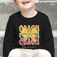 Coach Team Groovy Coquette Bow Cute Back To School Graphic Toddler Long Sleeve Tee Coach Team Groovy Coquette Bow Cute Back To School Graphic Toddler Long Sleeve Tee