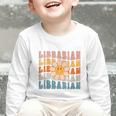 Librarian Retro Find Me At The Library Back To School Graphic Toddler Long Sleeve Tee Librarian Retro Find Me At The Library Back To School Graphic Toddler Long Sleeve Tee
