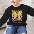 School Nurse Groovy Coquette Bow Cute Back To School Graphic Kid Sweatshirt School Nurse Groovy Coquette Bow Cute Back To School Graphic Kid Sweatshirt